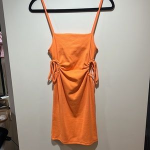 Summer orange dress with cut outs on the waist